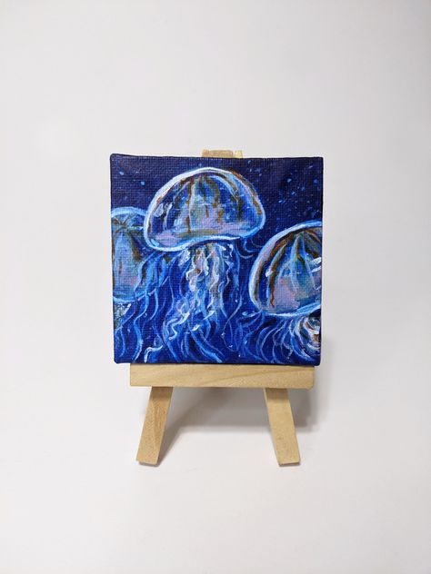 "Original acrylic painting on 3\"x3\" mini canvas. Comes with easel for easy Display! An adorable decoration sure to appeal to lovers of tiny things. This listing is only for the painting pictured. Once it's gone, it's gone! Time-lapse of the creation of this painting: https://www.tiktok.com/@arc_ada/video/6931150579297225989?lang=en&is_copy_url=0&is_from_webapp=v1&sender_device=pc&sender_web_id=6904872419653486086 See more off my work: https://linktr.ee/Arc_ada" Mini Canvas Paintings Idea, Mini Easel Painting, Mini Canvas Ideas Easy, Things To Paint On Mini Canvas, 4x4 Canvas Painting Ideas, Easy Canvas Painting For Boyfriend, Tiny Canvas Painting Ideas Easy, Paint Small Canvas, Tiny Painting Ideas