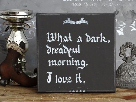 "Morticia WHAT A DARK MORNING Victorian Goth Wall Plaque Addams Family Quote Gothic Dark Wall Art Decor, Occult Spooky Creepy Halloween Fall Yet another one of all the wonderful sayings of Morticia Addams with total measures: 7.9 x 7.9\" (20 x 20 cm) / depth: 0.6\" (1.5 cm). Canvas sign in distressed dusty black base, hand lettered in a deep and indistinct white - \"What a dark, dreadful morning. I love it.\"  Intentionally done with a technique when ink does fade a little bit and hand distressed canvas for a better rustic effect. I use blackletter / gothic calligraphy / Old English Letter font style of lettering.  Letters are purposely made a little sloppy, with a rustic touch. I believe that this is exactly what you like, because the perfection of templates is available on many websites Goth Rustic Decor, Gothic Chalkboard Art, Addams Family Home Decor, Diy Gothic Decor Crafts Victorian, Adams Family Decor, Wednesday Addams Decor, Adams Family Decorations, Addams Family Halloween Decorations, Farmhouse Gothic Decor