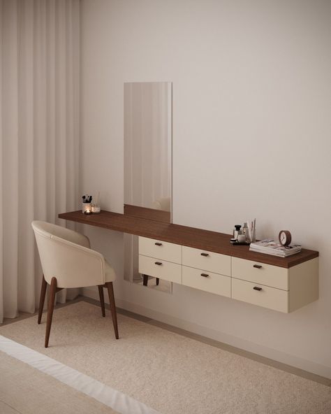 Modern vanity with a wooden floating desk, light-colored drawers, and a vertical rectangular mirror on the wall. A beige upholstered chair with wooden legs is positioned in front of the desk, and the surface holds a few personal items, including a clock and some cosmetics. The space has a neutral, minimalist aesthetic with light tones and soft lighting. Aesthetic Desk Chair, Neutral Minimalist Aesthetic, Future Room, Floating Desk, Vanity Area, Mirror On The Wall, Neutral Minimalist, Upholstered Chair, Modern Vanity