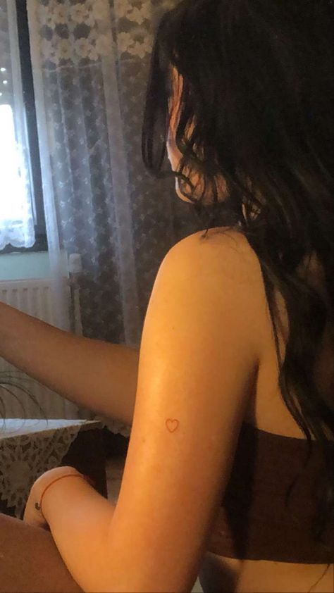 Heart Tattoo Kylie Jenner, Kylie Heart Tattoo, Kylie Jenner Tattoo Heart, Back Of Arm Heart Tattoo, Kylie Jenner Red Tattoo, Small Dainty Shoulder Tattoos, Kylie Jenner Red Heart Tattoo, Heart On Arm Tattoo, Tiny Tattoo Placement Ideas Hidden