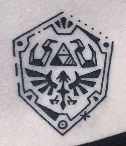 Rupee Tattoo Zelda, Minimal Zelda Tattoo, Nerd Tattoo Ideas For Men, Zelda Oot Tattoo, Loz Tattoo Ideas, Tattoo Ideas Zelda, Hylian Shield Tattoo, Gamer Tattoos Men, Zelda Tattoo Design