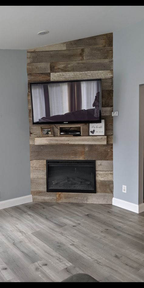 Beautiful way to dress up an electric fireplace! We created this corner fireplace for about $600 including the fireplace and barn wood. It is definitely the focal point of the room and we no longer need the eye sore that was our entertainment center. Entertainment Center Ideas Corner, Corner Tv Entertainment Center Ideas, Electric Fireplace Ideas With Tv Corner, Faux Corner Fireplace With Tv, Built In Corner Entertainment Center, Diy Corner Fireplace Tv Wall, Corner Entertainment Center Diy, Diy Electric Fireplace Corner Wall, Corner Built In Fireplace And Tv Diy