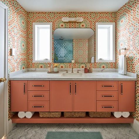 This bold, colorful bathroom features a wall-to-wall coral vanity and coordinating coral and blue geometric tile walls. A traditional white marble countertop balances the dynamic color and bold patterns. Coral Bathroom, Under Stairs Nook, San Francisco Victorian, Colorful Bathroom, Tile Walls, Bathroom Wall Hanging, Home Paint Color, Fireclay Tile, Bathroom Features