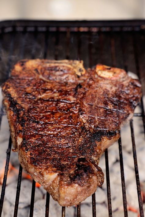 A T-bone Steak cooking on a charcoal grill. Tbone Steak Recipe Grilled, Cooking T Bone Steak, Tbone Steak Recipe, Grilled T Bone Steak, Steak Cooking, Cooking The Perfect Steak, Grilled Steak Recipes, T Bone Steak, Easy Grilling