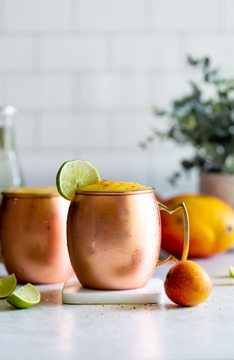 Frozen Mango Moscow Mule. A delicious mango twist to the traditional Moscow Mule made with spicy ginger beer, frozen mangoes, fresh lime, and a dash of Tajin for some spice! Mango Moscow Mule, Mango Mule Recipe, Mango Moscow Mule Recipe, Mango Mule, Watermelon Vodka Slush, Vodka Slush, Liquid Therapy, Moscow Mule Recipe, Mule Cocktail