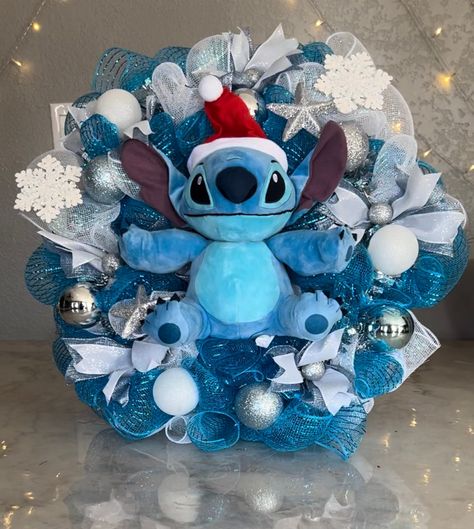 Stitch Christmas Wreath.  Made in November 2023. Made out of mesh, ornaments, ribbon, stuffed animal, and led lights. Stitch Tree Christmas, Stitch Christmas Tree Ideas, Lilo And Stitch Room Ideas, Stitch Ornaments Diy, Stitch Christmas Decorations, Disney Christmas Decor, Merry Stitchmas, Stitch Bedroom, Stitch Christmas Tree