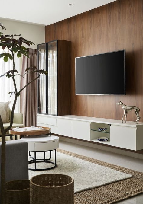 The modern living room interior design was built around this custom built TV unit. The wall is finished in a veneer panelling, topped with a sleek drawer unit to house all storage items. A glass door cabinet at the far end, which doubles up as a bookcase and display cabinet, helps complete the look.

#residence #interiordesign #apartment #interiors #homedesign #homedecor #interiordecor #home #design #custom #furnituredesign #furniture #livingroom #cabinets #tvunit #wall #panelling #residential Veneer Tv Unit Design Modern, Sleek Tv Unit Design For Bedroom, Tv Unit Glass Design Modern, Tv Unit With Glass Doors, Tv Unit Glass Door, Display Unit Living Room, Tv Unit With Display Cabinet, Wall Paneling Tv Unit, Veneer Wall Panelling Design Living Room