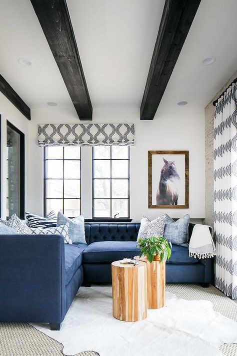 Wonderfully decorated blue and white living room is furnished with a blue tufted low back sectional accented with white and blue pillows. Black Beams, Ceiling Beams Living Room, Beams Living Room, Blue And White Living Room, Transitional Living Rooms, White Ceiling, White Living Room, Pictures Ideas, Front Room