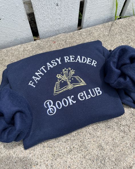 Fantasy book club Embroidered sweatshirt Book lover fashion Reader club apparel Fantasy-themed clothing Bookworm fashion Literary sweatshirt design Fantasy book enthusiast Reading community fashion Book club merchandise Novel-inspired fashion Reader lifestyle apparel Fantasy bookworm style Book Hoodies, Bookworm Aesthetic Outfit, Literary Sweatshirt, Embroidery Seasons, Book Club Outfit, Bookworm Fashion, Book Sweatshirts, Bookworm Style, Book Merchandise