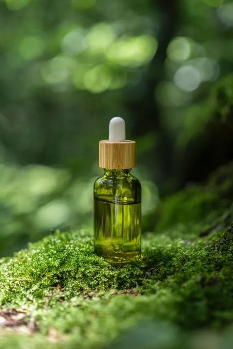 Green glass dropper bottle for essence oil or serum. Oil Dropper, Products Photography, B Roll, Glass Dropper Bottles, Moss Garden, Dropper Bottle, Beauty Products Photography, Dropper Bottles, Content Ideas