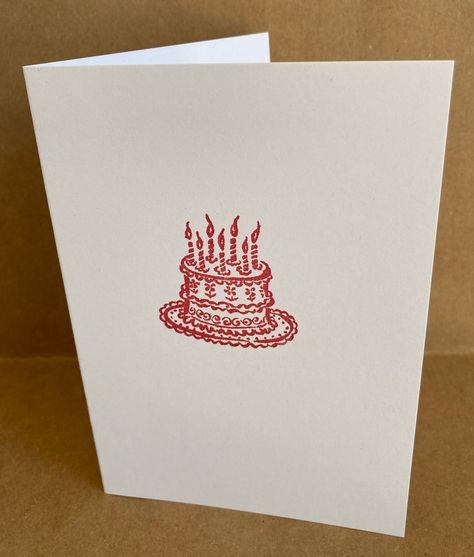 A simple and classic hand stamped greetings card with an image of a birthday cake stamped in red ink.  Card measures 11.4cm x 16.2cm (4.5" x 6.4") and is left blank inside for your own message. The white card I use is 100% recycled and is 300gsm.  The brown Fleck Kraft envelope is made from 100% recycled paper and has a really natural feel.  The clear bag that protects the card is fully biodegradable and compostable (made from corn starch). The bag is made in the UK from film that has been accredited to 'OK biobased' and DIN EN 13432. It is made from annually renewable PLA derived from vegetable starches (potato, sugar beet etc.). When composted, the bag will break down to CO2, H20 and biomass which can then be reused in the eco system to make new plants.  For any enquiries please do get i