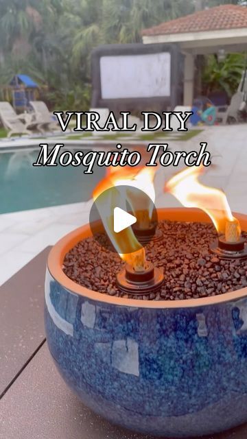 Jennifer Amarteifio | DIY Home | Faith | Lifestyle on Instagram: "Super easy and beginner friendly DIY project that keeps those pesky mosquitos away and also elevates your outdoor space! I made this last summer and it’s still holding up and works very well! 

I purchased all my supplies from @walmart for under $50. You can find all items on my Walmart storefront 🔗 in bio. 
+ planter
+ 3 torch canisters
+ bottle of tiki torch fuel + sand
+ aquarium gravel

#diytabletorch #mosquitorepellant #mosquitohack #diyoutdoorprojects #summerdiy #summerprojects #womenwhodiy #tabletopfirepit #diydecor #diyhomeprojects #diyideas #walmartcreator #walmartpartner #tikitorch
#tabletoptikitorch" Deck Tiki Torch Ideas, Diy Bug Repellent Torches, Mosquito Repellent Candles Diy, Diy Mosquito Repellent Tiki Torches, Citronella Candles Diy Outdoor Parties, Tiki Torch Planter Diy, Outdoor Tiki Torch Ideas, Tiki Torches Around Pool, Diy Tiki Torch Fire Bowl