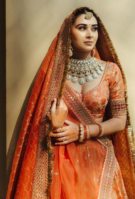 Photo of unique bridal jewellery with an orange lehenga Orange Pink Bridal Lehenga, Red Orange Bridal Lehenga, Orange Red Bridal Lengha, Indian Bridal Photos Wedding Dresses, Orange Wedding Lehenga Indian Bridal, Unique Bridal Looks Indian, Rust Wedding Lehenga, Rustic Orange Bridal Lehenga, Indian Bridal Lehenga Pastel