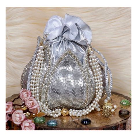 Elegance in silver. Our Silver Beaded Lotus Potli Bag is a showstopper at any event. 💫 Price: ₹1699/- DM us to buy Free shipping within India ✈️ Shipping worldwide 🌍 Code : 05/T08S Follow @clutches_by_rohika for more designs. #GoldAccessories #PartyReady #HandcraftedBeauty #ClutchesByRohika #FestiveFashion #BeadedBag #LuxuryAccessories #clutchesbyrohika #SilverAccessories #Fashionista #Handmade #lotuspotli Silver Potli Bag For Wedding And Festive Occasions, Silver Traditional Party Clutch, Traditional Silver Clutch For Festivals, Luxury Festive Potli Clutch Bag, Silver Handwork Clutch Bag, Lotus Potli Bag, Indian Clutch, Purse Wedding, Potli Bag