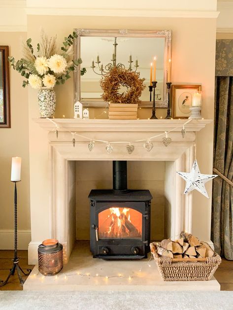 White fireplace with flowers on the mantle Log Burner Mantle Ideas, Cottagecore Mantle Decor, Cottagecore Fireplace Mantle, Cottage Core Mantle, Cream Fireplace Living Room, Small Fireplace Mantle Decor, Small Sitting Room With Fireplace, Fireplace Mantal Decor, Cottage Mantle Decor