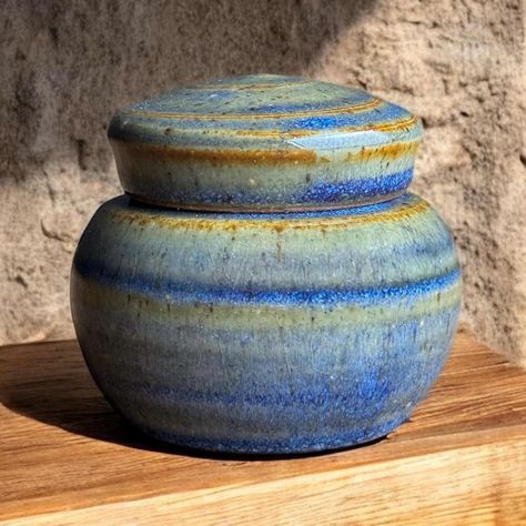 This is a beautiful keepsake mini sized urn.   I have made this extra small urn on my potters wheel using soft porcelain clay.   The approximate capacity is 5 cubic inches. (equal to about 5 lbs. before cremation) or 1/4 -1/3 cup.  Overall dimensions are 2.5" tall x 2.5" wide.  Please feel free to message me with any questions -Extra Helpful Information-  1.) This glaze surface is glossy. 2.) All of my pieces are one of a kind and handmade.   3.) Your order comes with easy to follow instructions for permanent sealing.   4.) If you need expedited or overnight shipping don't hesitate to message, we can do it.   5.) If your overseas please message so I can provide accurate shipping costs. 6.) I'm happy to help with additional information, images or anything you may need to select the perfect Small Urns, Keepsake Urns, Porcelain Clay, Potters Wheel, We Can Do It, Style Expert, Handmade Pottery, Gift Baskets, Glaze