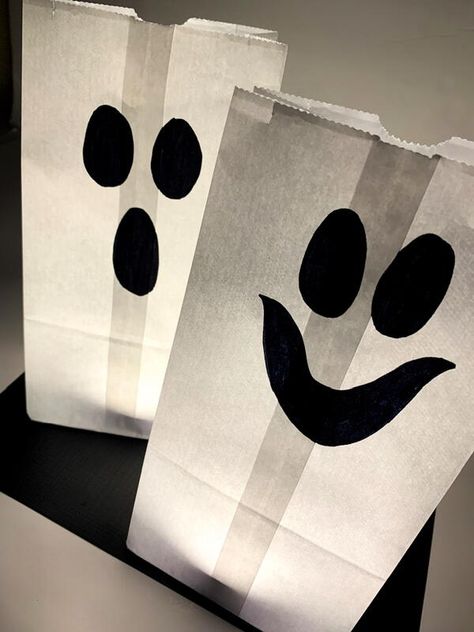 Halloween is just around the corner and that means it's time to start thinking about what decorations you want to put up. Paper bag ghost luminaries are a great option because they're easy to make and they look really spooky. Plus, they're perfect for both indoor and outdoor use. So if you're looking for something different this year, then check out these instructions on how to make your own paper bag ghost luminaries. You won't be disappointed! Decorating Paper Bags For Halloween, Paper Bag Illuminaries Diy, Halloween Paper Bag Treat Bags, Paper Bag Ghost Craft, Halloween Paper Bag Decorating Ideas, Halloween Brown Paper Bag, Paper Bag Halloween Crafts, Paper Bag Ghost, Ghost Luminaries