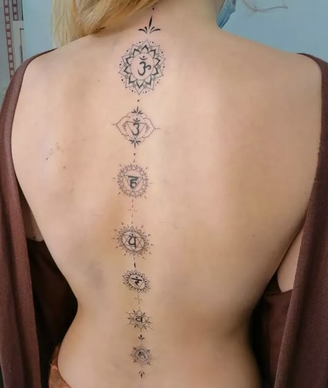 65+ Chakra Tattoo Ideas To Help You Ascend To A Higher Plane Chakras Back Tattoo Women, Chakras Down Spine Tattoo, Buddha Spine Tattoo, Yoga Spine Tattoo, Hindu Spine Tattoo, Kundalini Spine Tattoo, Spine Tattoo Chakra, Chakra Tattoo Back, Chakras Spine Tattoo