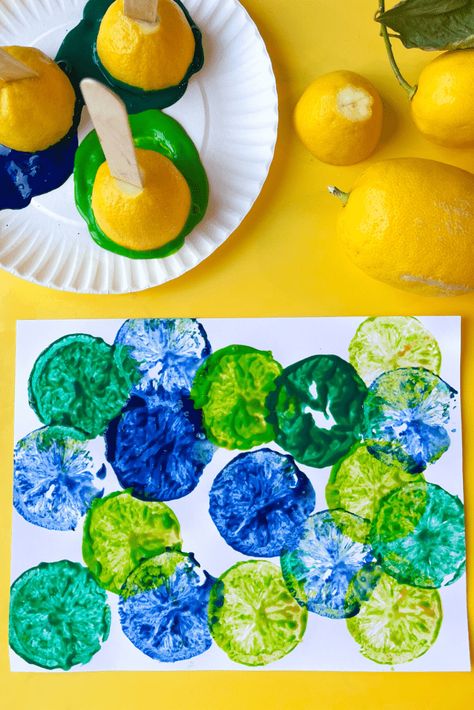 A plate with lemon stamps sits next to fresh lemons. Below both sits a white piece of paper covered in lemon stamp art prints in cool colors (greens and blue). Lemon Stamp, Roll Ups Recipes, Lemon Painting, Lemon Art, Green Lemon, Fruit Roll, Fruit Roll Ups, Friends Art, Cool Colors