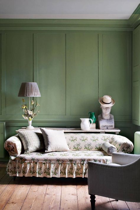 This country-style living room styled by Gabby Deeming has panelled walls painted Farrow & Ball's 'Breakfast Room Green', a soft olive. An antique sofa has been covered with a loose cover in Colefax & Fowler's legendary Bowood chintz. A trestle table displays an interesting collection of antiques including a vintage tole flower lamp and bust of Napoleon. Paint colour ideas | House & Garden Breakfast Room Green, English Country House Style, Green Painted Walls, Country Style Living Room, Style Anglais, Paint Your House, Room Green, English Country Decor, Casa Country