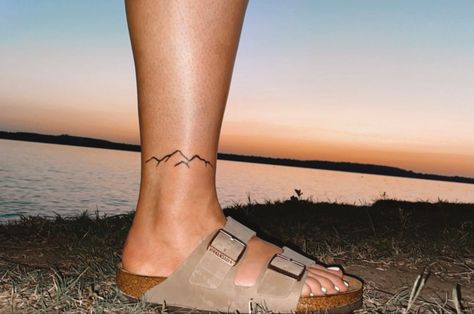 Mountain Tattoo Ankle Band, Mountain Sunset Tattoo Minimalist, Ankle Mountain Tattoos For Women, Elegant Mountain Tattoo, Mountain Wrap Tattoo, Mountain Tattoo On Ankle, Mountain Ankle Tattoo Wrap Around, Mountain Foot Tattoo, Ankle Tattoo Mountain