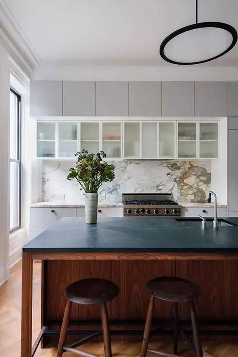 a stylish kitchen island with a black countertop - Shelterness White Herringbone Tile Backsplash, Kitchen Counters And Backsplash, Paonazzo Marble, White Shaker Style Kitchen, Townhouse Remodel, Glass Upper Cabinets, White Marble Backsplash, Soapstone Kitchen, White Herringbone Tile