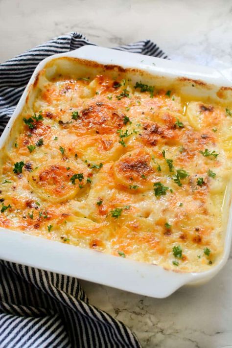 Gouda Au Gratin PotatoesGouda Au Gratin potatoes are a cheesy, creamy potato dish that will make your taste buds happy. This recipe is easy to follow and doesn't require many ingredients. https://smellslikedelish.com/gouda-au-gratin-potatoes/ You'll love the flavor of the Gouda cheese combined with the potatoes and cream with your next Maple Bourbon Glazed Ham. So good, you'll want to make this dish for every special occasion! Easy Scalloped Potatoes Recipe, Scalloped Potatoes Easy, Au Gratin Potatoes, Gratin Potatoes, Canned Potatoes, Smoked Gouda Cheese, Scalloped Potato Recipes, Potatoes Au Gratin, Gouda Cheese