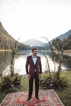 With a romantic wedding setting, you want to make sure that your wedding attire is up to par as well. We love this dreamy maroon suit with black edges for a groom. It's romantic, handsome, and is one of kind making it perfect for a groom.  #groomsmen #groom #weddingattire #weddingtips Groom Suit Red, Boho Mountain Wedding, Boho Wedding Groomsmen, Romantic Wedding Setting, Mountain Wedding Ideas, Boho Mountain, Burgundy Tuxedo, Modern Groom, Groomsmen Bowtie