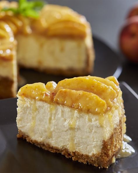 A classic cheesecake has been elevated with Golden Peach topping.  INGREDIENTS: Crust 1 1/4 cups graham cracker crumbs 1/4 cup (4 tablespoons) butter, softened or melted 2 tablespoons Domino® Golden Sugar  Filling 1 cup peeled and sliced peaches, divided (for puree) 3/4 cup Domino® Golden Sugar 3 (8 oz.) packages cream cheese, softened 2 large eggs 1/2 teaspoon vanilla extract 1/4 cup sour cream 2 tablespoons all-purpose flour Glazed Peach Topping Peaches And Cream Cheesecake, Glazed Peaches, Peach Cheesecake, Cream Cheesecake, Classic Cheesecake, Peaches And Cream, Canned Peaches, Peach Recipe, Bakery Shop