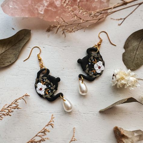 brb ordering more pearl beads for these dark cottagecore teapot earrings. 🖤🌿 I’m seriously in love. #handmadeearrings #clayearrings #darkcottagecore #polymerclayartist #handmadejewelry #uniqueearrings #darkaesthetic #whimsigoth #earrings #chattanoogaartist #darkfloral #witchyvibes #darkacademia #jewelryhandmade #earringmaker #jewelrydesigner #clayartist #polymerclayearrings #teapots #etsy #floralearrings Cottagecore Teapot, Whimsigoth Earrings, Teapot Earrings, Clay Sculpting, Dark Cottagecore, Sculpting Clay, Floral Tea, Witchy Vibes, Dark Floral