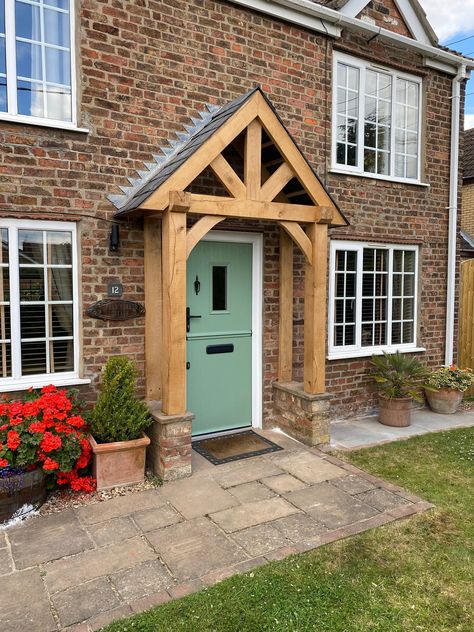 Solid Oak Porch Frame made to Order. Expertly Carved out of Solid Green untreated Oak, Sanded and ready to be assembled and installed. This Product can be installed for an additional fee if requested. WIDTH: The width on the listing is the overall width (roof overhand included) The inside space inbetween that for the opening is approx 60cm less than the overall width. We appreciate that not every width will be to your liking so if you're unsure, Round what width you want up to the nearest amount when ordering. Want it wider? Drop us a message!  All roofs are at 45 Degrees unless specified. DEPTH. Standard Depth is Approx. 60cm unless specified. Please note we can make this up to 90cm at NO EXTRA CHARGE!) We can cater to exact measurements if needed to make sure you're porch is perfect. PLE House Exterior Porch, Brick Entrance Front Porches, Porch Front Door, Back Door Styles, External Porch Ideas, Front Porch Cover, Green Oak Porch, Porch Arch, Pitched Porch