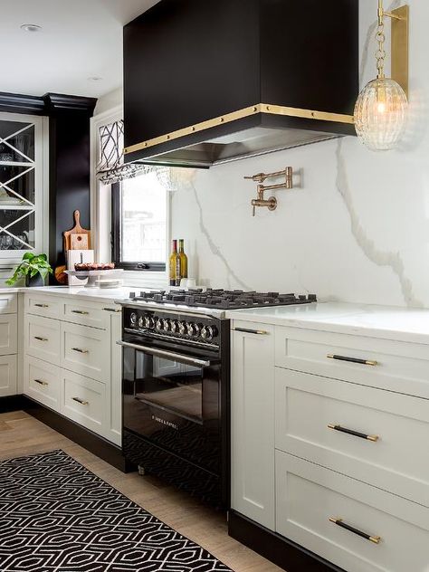 A black trellis runner sits in a black and white kitchen in front of a black Fisher and Paykel Stove placed between white shaker drawers donning black and gold pulls. Modern Fridge, White And Gold Kitchen, Full House Remodel, Kitchen 2022, Kb Homes, White Shaker Kitchen, White Wall Tiles, Pantry Remodel, Kitchen Goals