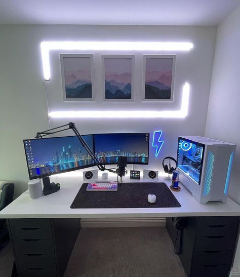 Would you add anything to this clean setup? 👇 [via @alhcomps] I really like the clean look of this gaming setup. First thing that catches your eyes are the LIFX lights that are surrounding the posters. It highlights that space so well while radiating good light. Next on the wall, he has a blue lightning bolt neon sign which goes well with this blue and white RGB theme. I like how the desk is organized. Cable management is very clean. He is using the Lian Li Lancool II White as the PC case whi Lifx Lights, Clean Setup, Gaming Desk Setup, Best Gaming Setup, Computer Gaming Room, Gaming System, Computer Desk Setup, Gamer Setup, Pc Setups