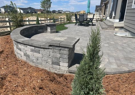 Excellent look and unique design to this backyard paver patio with a sitting wall. Great for entertaining Paver Patio With Retaining Wall, Fire Pit Ideas Backyard Square, Sitting Wall Patio, Paver Patio With Steps, Patio With Stone Wall, Paver Patio Ideas On A Budget, Rock Pavers, Sitting Wall, Backyard Retaining Walls