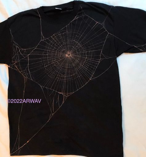 Spiderweb handpainted with bleach on to a black T-shirt. Available with just the spiderweb on the front, or connecting round to a second spiderweb on the back. If you're unsure what size to choose I recommend picking a larger one as fruit of the loom T-shirts are on the smaller side. Halloween Clothing Ideas, Bleach Spider Web Shirt, Skull Clothing Design, Spiderweb Bleach Shirt, Spider Web Bleach Design, Black Shirt With Bleach Design, Spider Bleach Design, Bleached Shirt Designs Alt, Bleach Painting Clothes Goth