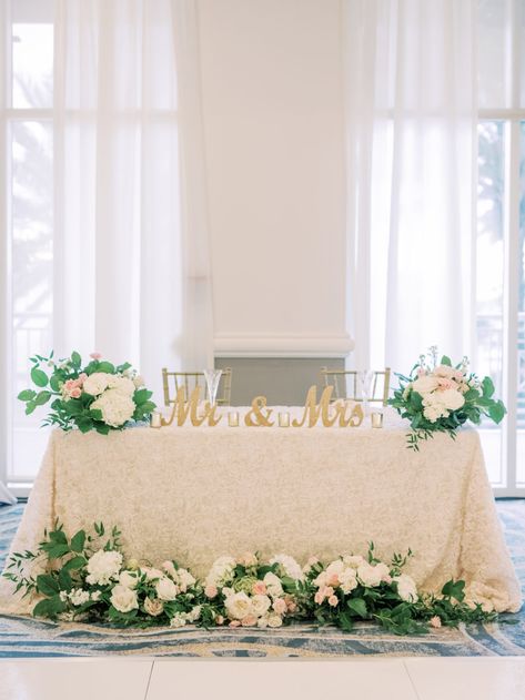 Timeless Romantic Sweetheart Table with Ivory Floral Linen, Lush Greenery and White, Blush Pink Roses and Hydrangeas, Gold Mr and Mrs Table Sign, Chiavari Chairs | Tampa Bay Wedding Planner Special Moments Event Planning | Wedding Rentals Kate Ryan Event Rentals | Wedding Venue Hyatt Regency Clearwater Beach Wedding Floral Arrangements Sweetheart Table, Blush Pink Sweetheart Table, Couple Head Table Wedding, Suiteheart Table Wedding, Long Sweetheart Table Wedding, Sweetheart Table Wedding Mr And Mrs Sign, Bride And Groom Table Decorations Simple, Sweet Heart Table Flower Arrangement, Wedding Decor Sweetheart Table