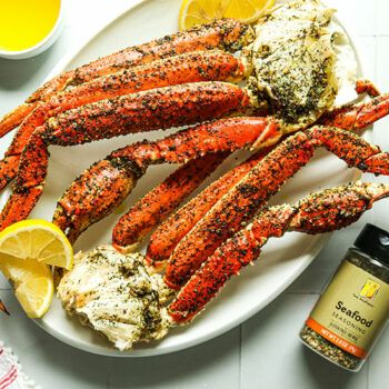 Easy Baked Crab Clusters | Heinen's Grocery Store Crab Clusters Recipe, How To Bake Crab Legs In Oven, Snow Crab Clusters Recipe, Baked Snow Crab Legs Oven, Baked Crab Legs Oven, Cooking Crab Legs, Cooking Crab, Baked Crab, Snow Crab Legs