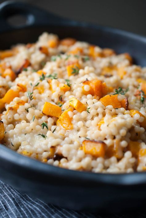 Cheesy Roasted Butternut Squash Couscous Casserole I used Israeli couscous in this dish because I love it’s shape and texture. I cooked it in coconut milk, mixed it in with the ghee roasted squash and piled on high the cheese. Obviously. Then it’s baked until melty and gooey. I mean, this dish is sinful and I absolutely love it. lifeisbutadish.com #butternutsquashsidedish #Israelicouscous Couscous Casserole, Butternut Squash Couscous, Butternut Casserole, Butternut Squash Side Dish, Couscous Recipe, Parmesan Roasted Potatoes, Pearl Couscous, Couscous Recipes, Cheesy Casserole