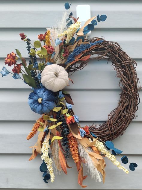 Beautiful Neutral Fall wreath to hang on your front door, family room, above fireplace, entryway. Anywhere. Also makes a great gift. Handmade and very full!! Premium faux floral with blues oranges and cream colors. Shown on a 14" base, Larger sizes will have extra floral and more pumpkins. Available on 14", 18", and 24" size grapevine base. Handmade and Made to order with premium quality artificial flowers and secured with zip ties and floral wire. Comes with a loop attached for easy hanging mad Blue And Orange Fall Wreath, Fall Wreaths With Navy Blue, Orange Fall Decor, Blue Fall Decor, Porch Wreath, All Season Wreath, Swag Wreath, Wreath Home Decor, Velvet Pumpkins