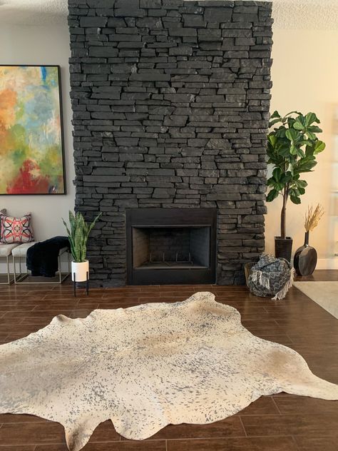 A natural gray stone painted with SW Tricorn Black in a matte finish. Black Painted Fireplace Stone, Painted Black Stone Fireplace, Paint Stone Fireplace Black, Painted Rock Fireplace Before And After, Black Painted Stone Fireplace, Black Rock Fireplace, Black Stone Fireplace, Fireplace Stones, Painted Rock Fireplaces