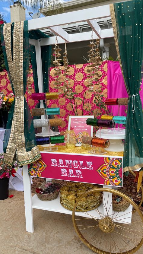 Bangle bar Mendi Party Decorations, Mendhi Taal Ideas, Henna Station At Party, Indoor Mehndi Decor, Bangle Station Mehendi, Mehendi Set Up, Mehendi Stall Ideas, Punjabi Reception Decor, Indian Wedding Diy Decor