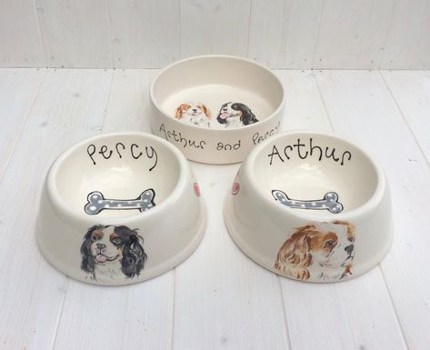 These beautifully hand painted ceramic dog bowls can be personalized with a name and a stylized portrait of your pet. The portrait of the pet will be on the outside and inside will be its name and a grey in the centre A wonderful personalised gift for any dog owner. ~Hand painted and personalised with a portrait and name ~ Glazed earthenware ~ Measures 20cm at base tapers to 15cm x 8cm ~ Dishwasher safe ~ Made in the UK You can either attach an image of your dog to the convo box or email it to C Pottery Painting Ideas Dog Bowl, Dog Plate Ceramic, Hand Painted Dog Bowl, Dog Ceramic Bowl, Dog Bowl Painting Ideas, Dog Bowl Pottery Painting, Ceramic Dog Bowl Painting Ideas, Ceramic Dog Bowls, Clay Dog Bowl