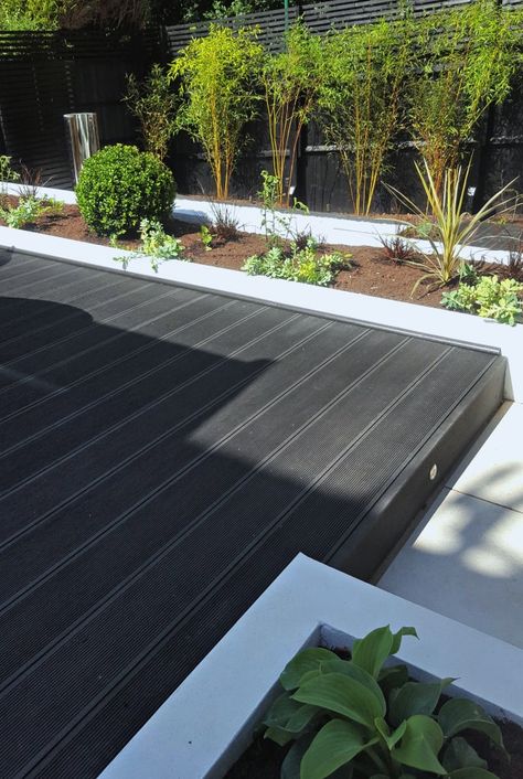 Browse images of black modern Garden designs: Composite Decking Platform. Find the best photos for ideas & inspiration to create your perfect home. Black Decking Garden, Modern Decking Ideas, Black Composite Decking, Black Patio Floor, Black Decking Ideas, Garden Floor Ideas, Black Decking, Garden Flooring, Black And White Garden