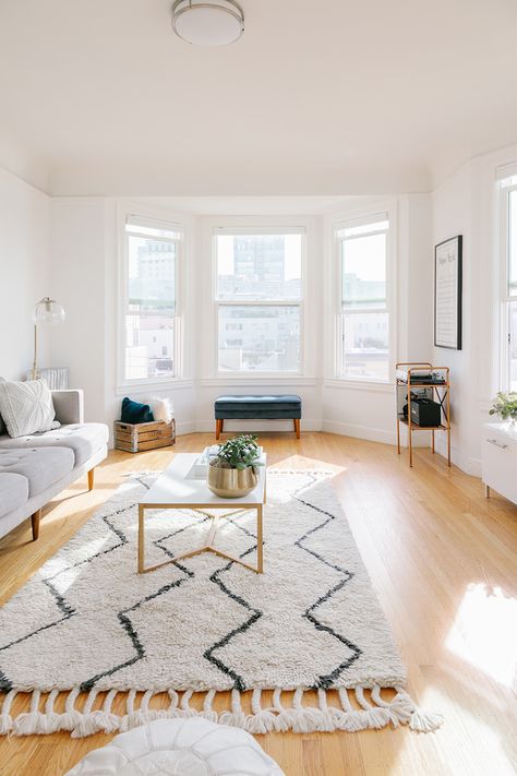 neutral living room inspo | muted rug | coffee table styling | bright living room | light wood floors | #theeverygirl Apartment Wood Floors, Rugs For Light Wood Floors Living Room, Light Filled Living Room, Living Room Decor Wood Floor, Rug For Light Wood Floor, Living Room Designs Wood Floors, Living Room White Walls Wooden Floor, Yellow Wood Floors Living Rooms, Living Room Light Floors