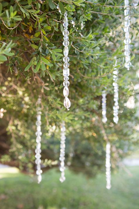 These gorgeous tree crystals are SO easy to make, learn how in this blog post! Suncatcher Wedding Decor, Crystals Hanging From Trees, Things To Hang From Trees Outdoors, Wedding Decor Crystals, Wedding Crystal Decor, Decorated Trees For Weddings, Crystal Wedding Decorations, Tree Decoration Wedding, Tree Wedding Decor