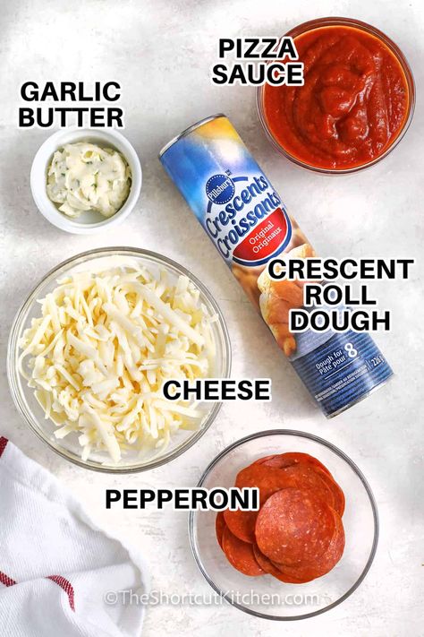 This easy recipe for crescent roll pizza makes a delicious and foolproof dinner, lunch, or snack in under 30 minutes. Just crack open a can of Pillsbury crescent roll dough and roll it out. Then spread with garlic butter and sauce and sprinkle with cheese, pepperoni, and your favorite pizza toppings. It bakes in minutes, with a mouthwatering crust that is crispy and tender with rich, buttery flavor. Pizza with crescent rolls is a great game day appetizer. #theshortcutkitchen Pizza Rolls With Puff Pastry, Pillsbury Pizza Bites, Pizza Roll Ups With Crescent Rolls, Crescent Pizza Roll Ups, Pizza Sticks With Crescent Rolls, Crossant Recipes Pizza, Recipe With Crescent Roll Dough, Pizza With Pillsbury Dough, Pillsbury Pizza Crust Ideas