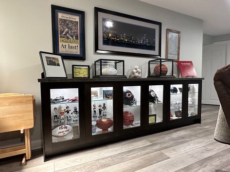 Sports Memorabilia Display Wall Man Cave, Sports Memorabilia Display Wall Shelves, Man Cave Memorabilia Display, Diy Display Case Ideas, Sports Memorabilia Office, Sports Display Wall, Sports Collectibles Display, Man Cave Jersey Display, Displaying Sports Memorabilia