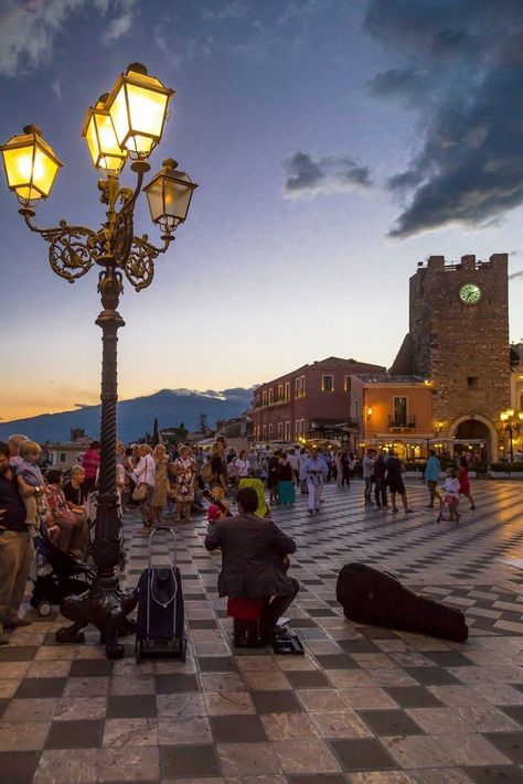 Taormina is a hilltop town on the east coast of Sicily. It sits near Mount Etna, an active volcano with trails leading to the summit. The town is known for the Teatro Antico di Taormina, an ancient Greco-­Roman theater still used today. Near the theater, cliffs drop to the sea forming coves with sandy beaches. A narrow stretch of sand connects to Isola Bella, a tiny island and nature reserve. Italian Trip, Sicily Travel, Italy Destinations, Taormina Sicily, Living In Italy, Italy Tours, Italy Aesthetic, Sicily Italy, Southern Italy