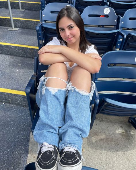 Female wearing white shirt with baggy ripped jeans and black vans at a baseball game Cold Gameday Outfit, Game Day Outfit Cold, Put Me In Coach, Baseball Game Outfit, Inspo Poses, Game Outfit, Game Day Outfit, Baseball Game, Baseball Games