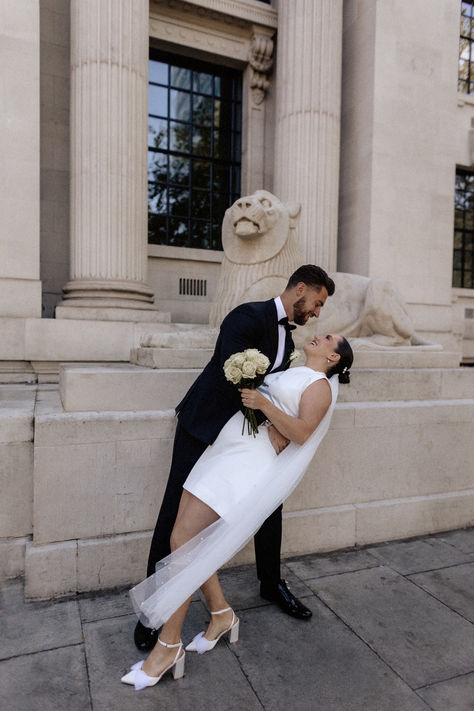 Bride in high neck short wedding dress with bow wedding shoes with wedding veil with groom in black tuxedo | monochrome wedding fashion | black tie | city wedding | registry office wedding | Joan Jellet Photography Registry Office Wedding Dress, Black Tie Dress Code, Registry Office Wedding, Monochrome Weddings, Bow Wedding Dress, Office Pictures, Black Tuxedo, Wedding Bows, Wedding Veil